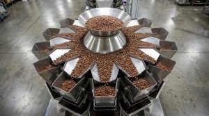 High-precision coffee bean weighing machine integrated with a vertical packaging line.